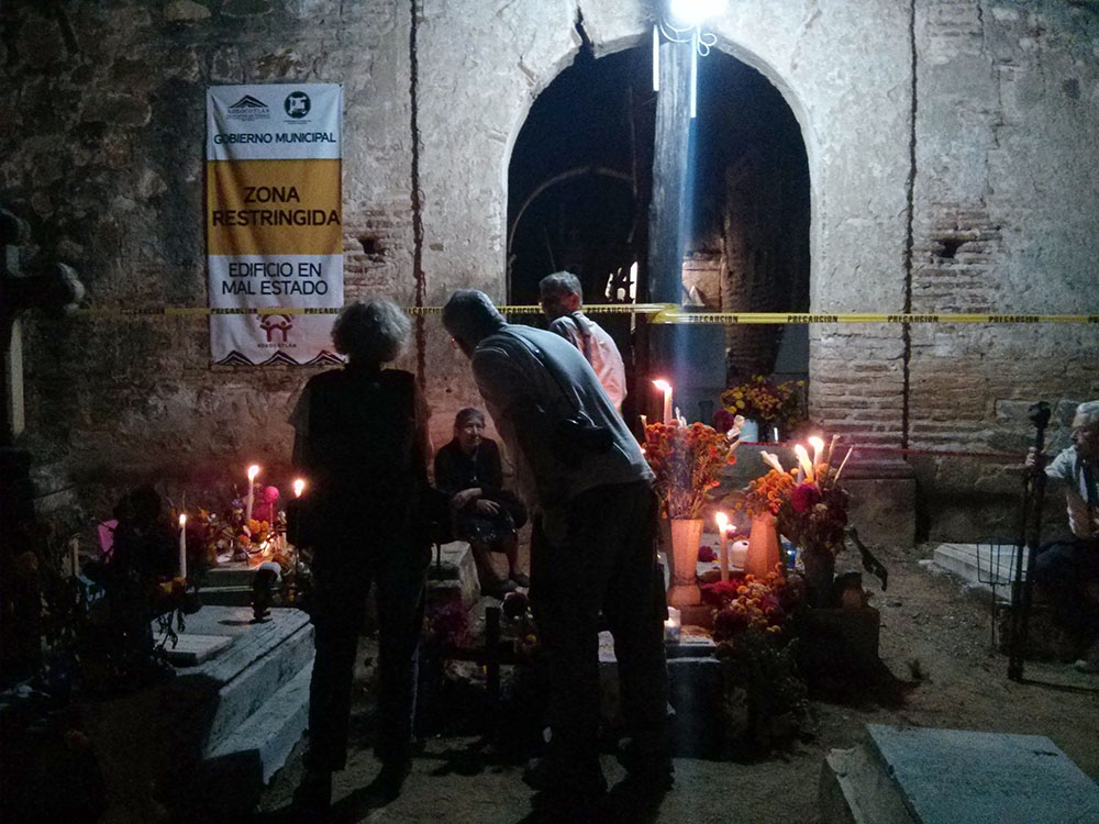 Four photographers focus on one woman in the old cemetery of Xoxocotlan. The photographer to the far left used a remote flash on her for at least 30 minutes. Photo: Nathaniel Chaney