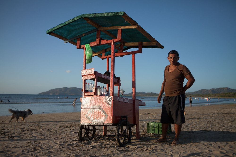 Tamarindo is the greatest little surf spot nobody had ever heard of...fifty-years ago. Now-a-days it is chuck full of boutiques, surf shops, and ex-pats all looking for a piece of the tourist dollar. As it is 'high season' in Costa Rica (from December to April), all the menus have been swapped and hotel rates lifted, making Costa Rica the most expensive country, by far, we have visited in Central America and often putting meals at or above American prices.  The town itself is a small main street that hugs the coast and then splinters into dirt roads that go off into neighborhoods.  The less adventurous traveler may enjoy Tamarindo for its faux third-world atmosphere and pervasive English, but veteran travelers can find less touristy spots with better surf elsewhere. The street food scene (usually budget friendly) is also pretty weak - this Snow Cone vendor was one of only three good finds Alex made in two days. Photo: Alex Washburn