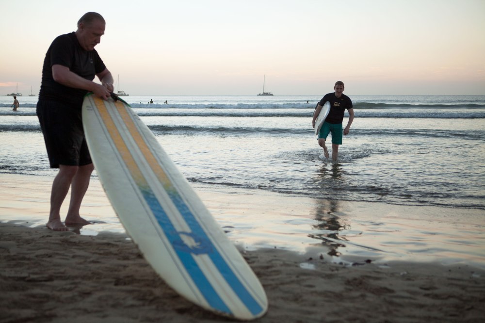 The waves in Tamarindo are great for beginners, and there are plenty of them that rove in packs known as Surf Schools, that take up all available ocean on the central beach.  Most of these schools focus on the mechanics of catching waves and little to no effort on teaching people about how to maneuver the board in water.  Subsequently you see lazy-ass Americans being pulled through the water while laying on their boards, lined up perfectly to catch a wave, and then being shoved off by the instructor and all they have to do is stand up (which most do not accomplish).  Regardless - having lived in Santa Cruz for close to two decades Dave and Nathaniel were excited to get in the water. Photo: Alex Washburn