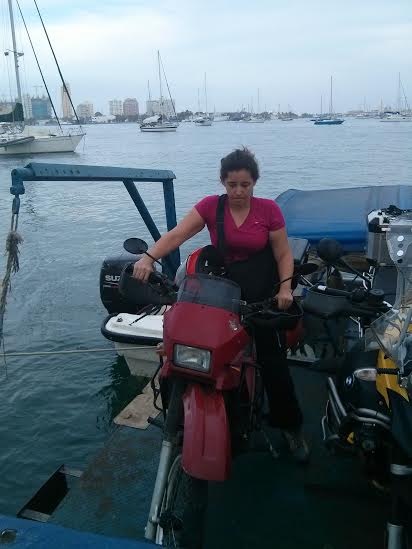 Alex nervously balances her bike on the floating dock that carried our six bikes from the Stahlratte to land in Cartagena. Photo: Alex Washburn