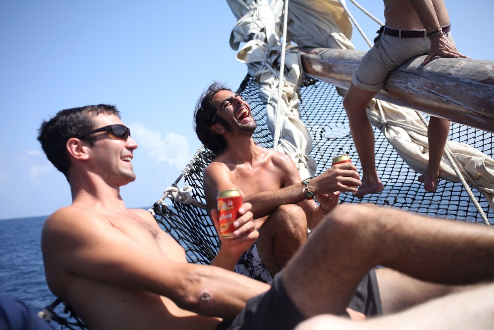 Jesse and Nico laugh at the bow of the ship as we motor out to the San Blas Islands. Photo: Alex Washburn