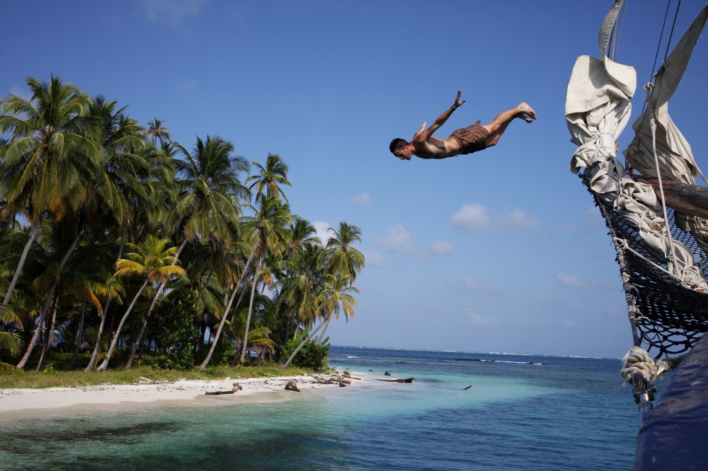 A frenchman jumps off the bow of the Stahlratte into the Caribbean Sea. Photo: Alex Washburn