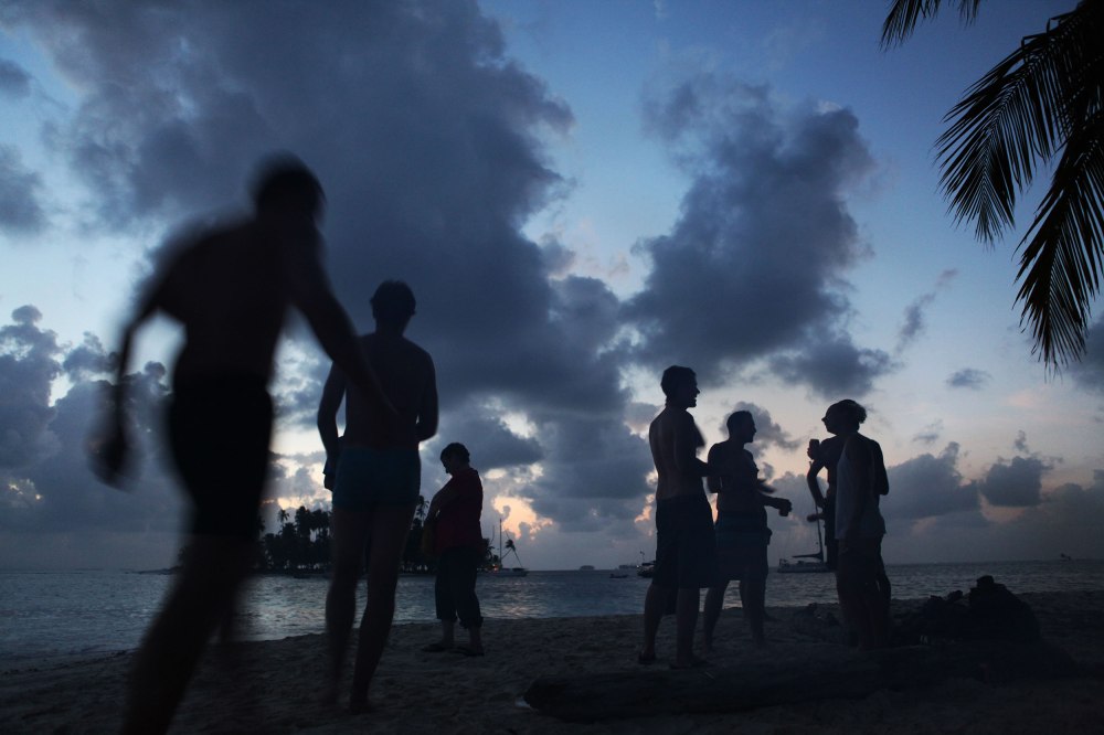 Passengers of the Stahlratte make conversation on the beach before heading back to the boat for the night. Photo: Alex Washburn