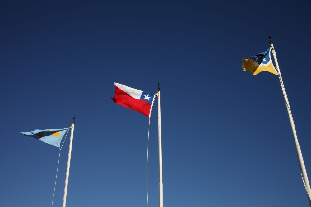Flags flap restlessly overlooking the Strait of Magellan. Photo: Alex Washburn