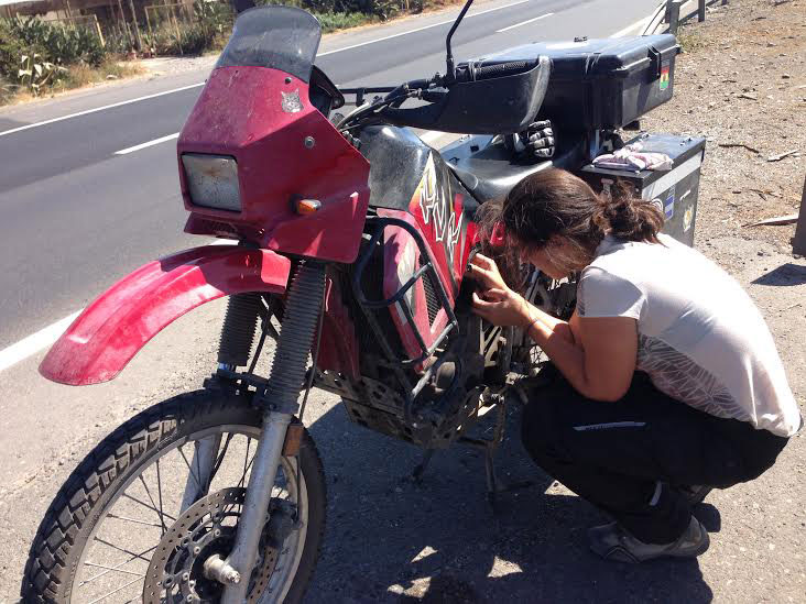 Alex tries to get her bike moving again on the side of the freeway. Photo: Alex Washburn